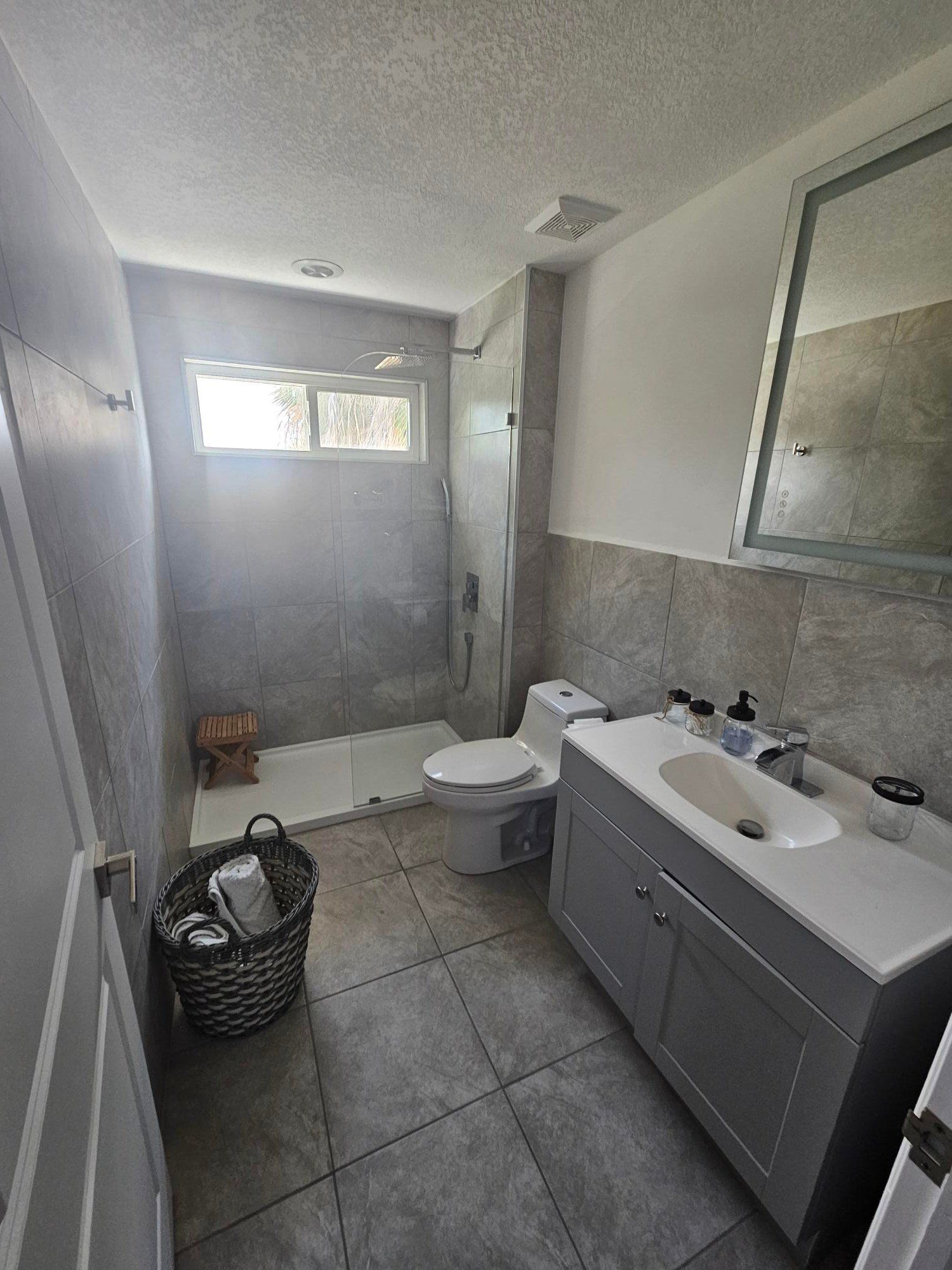 Bathroom vanity and tiled shower