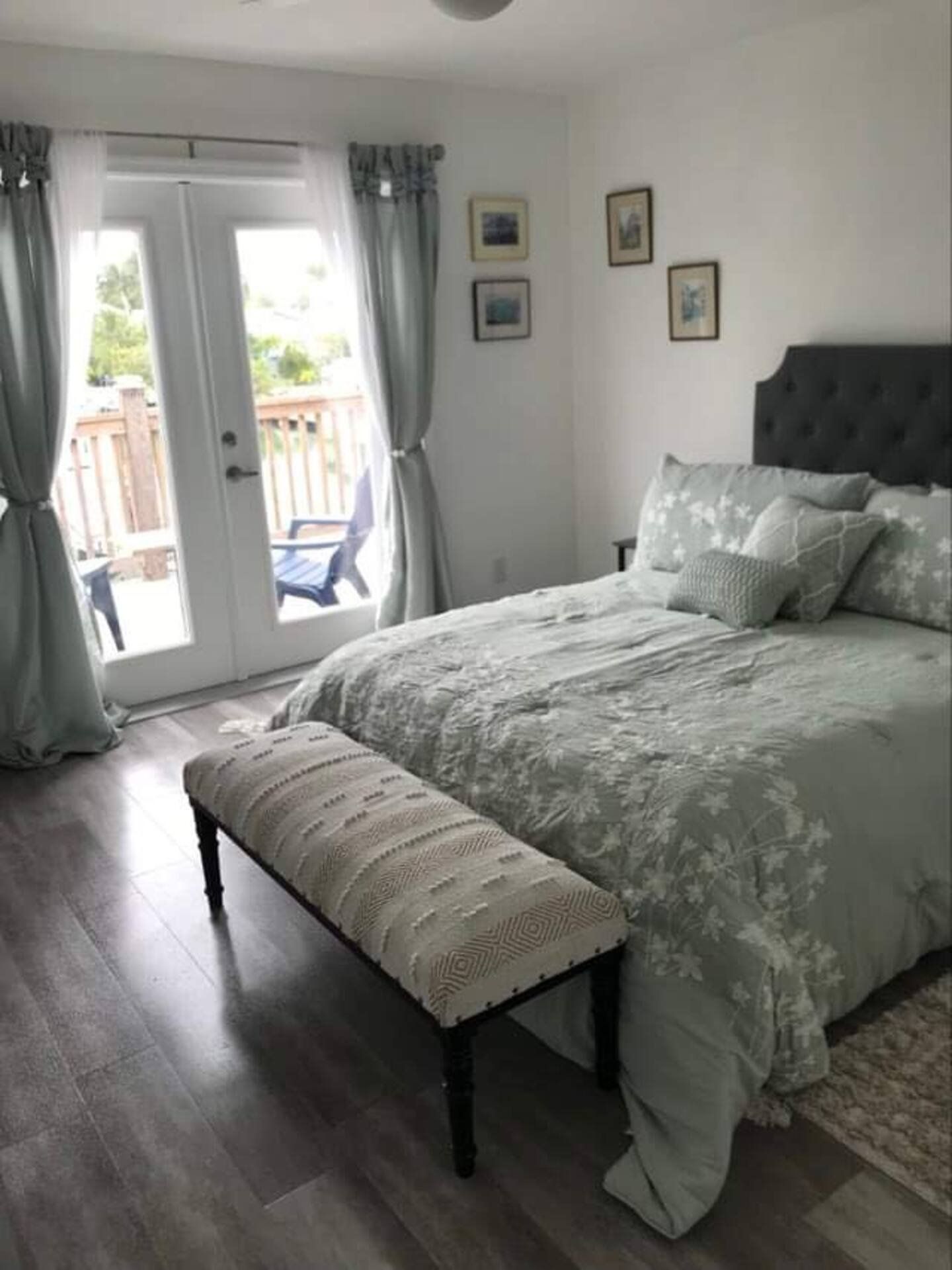 Master bedroom: king bed, bench and French doors to the deck