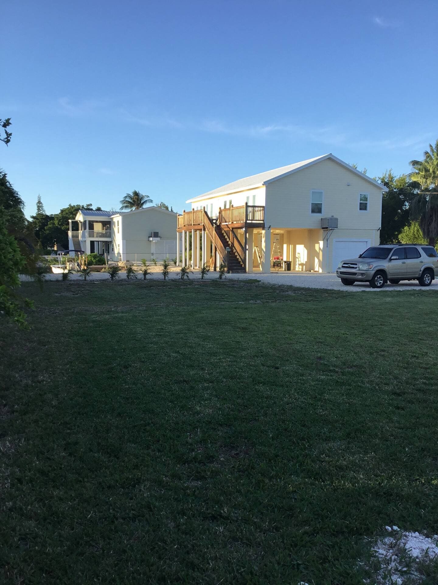 The house seen across the lawn in evening light
