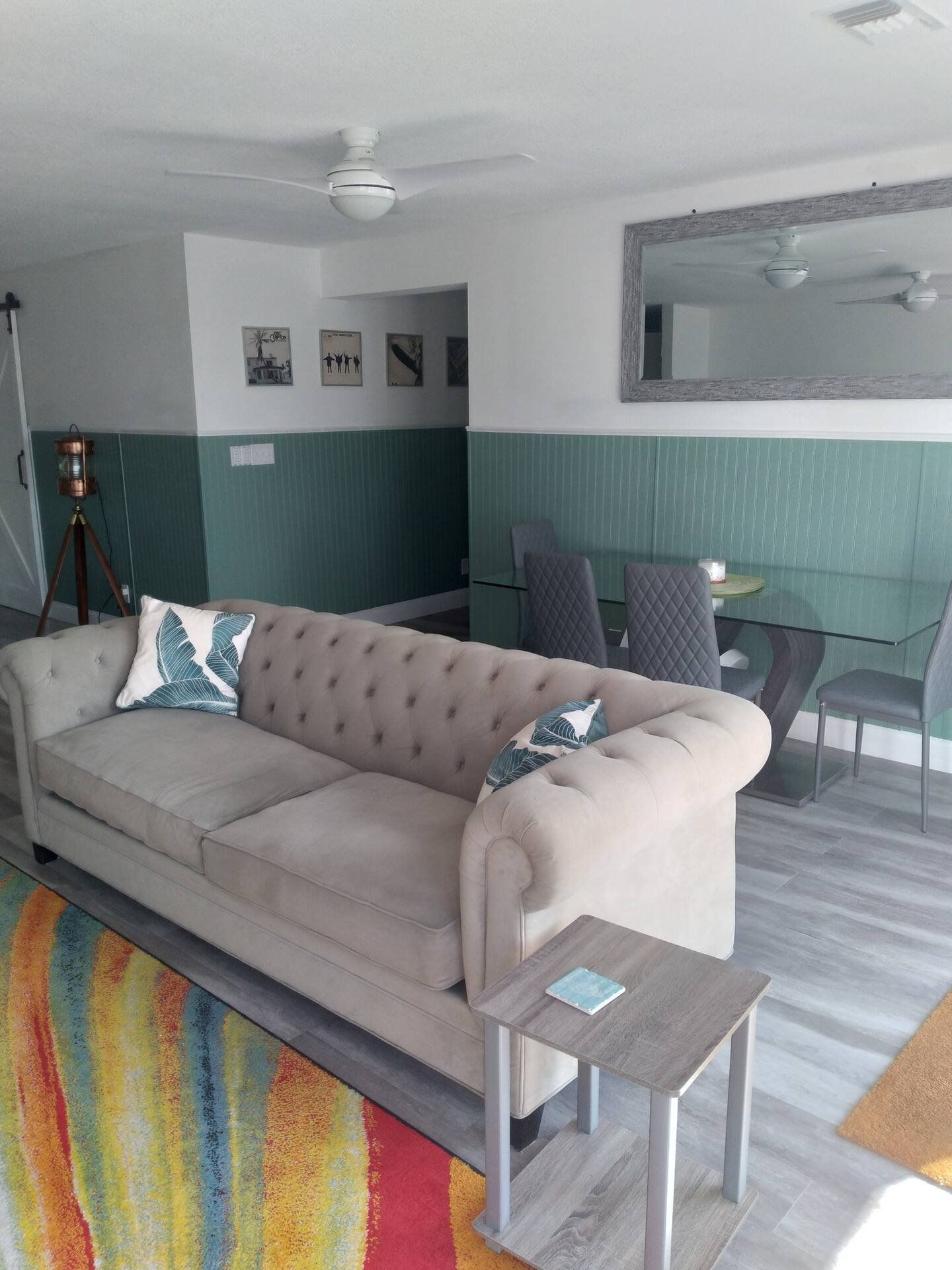 The open-plan lounge with a tufted sofa and dining area