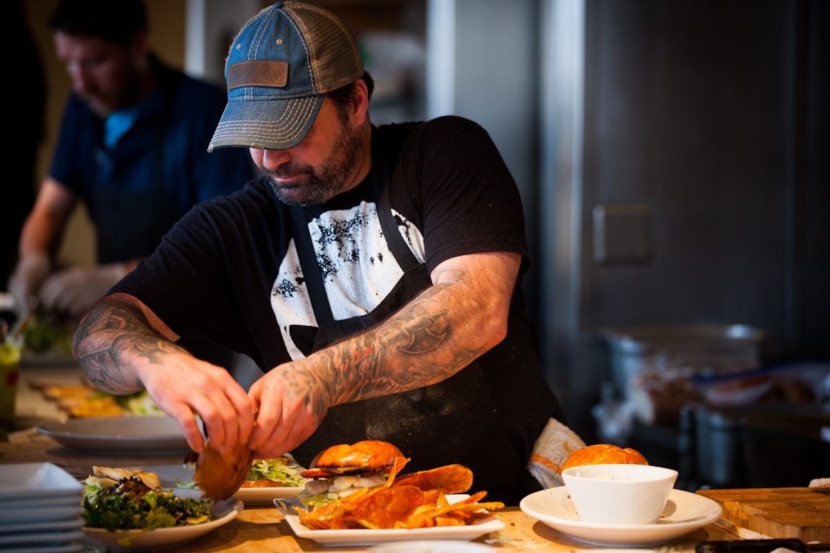 A chef plating dishes in a restaurant kitchen